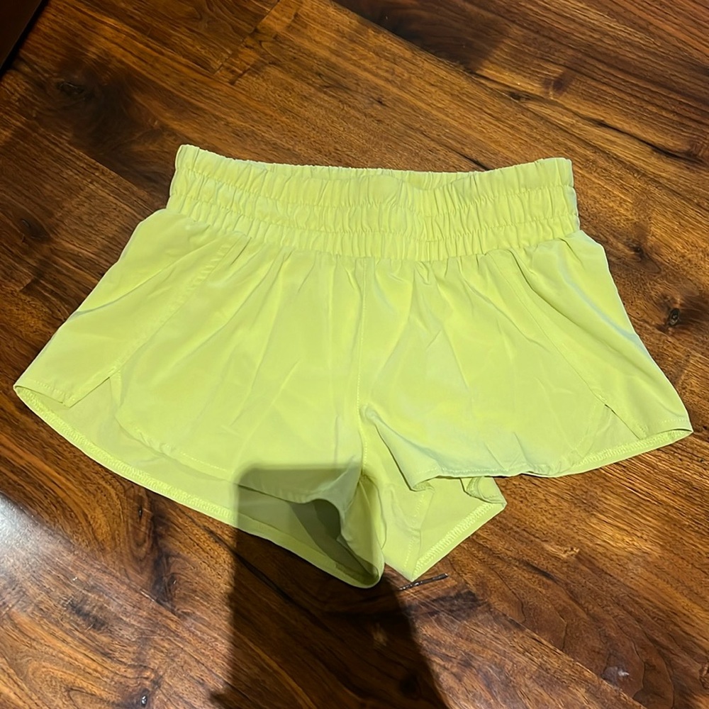 Yellow athletic shorts with underwear lining